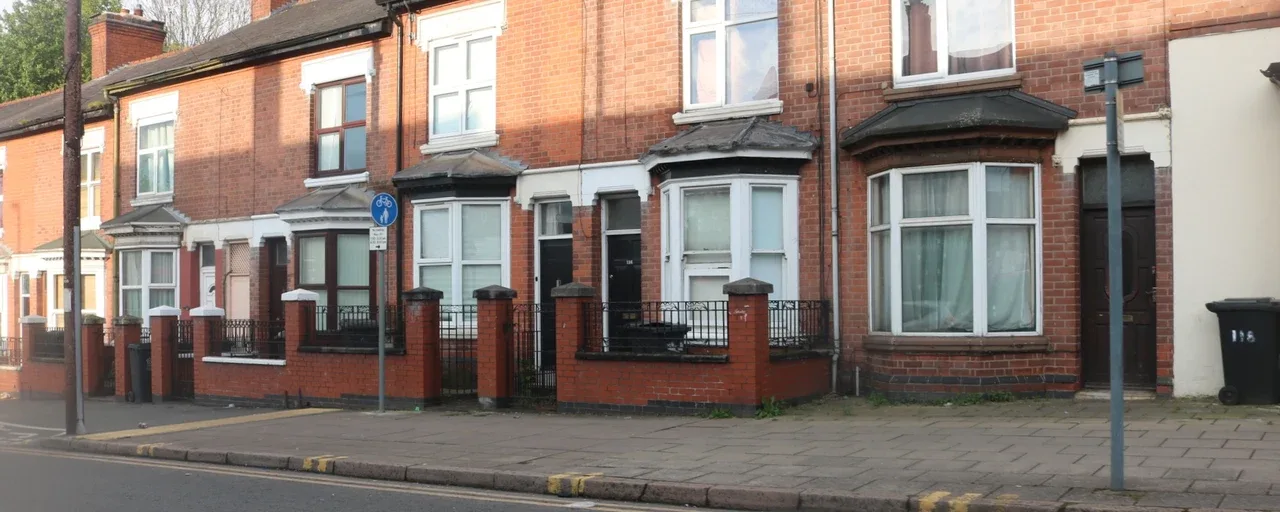 Red-brick terraced houses with bay windows on Fosse Road North, Leicester