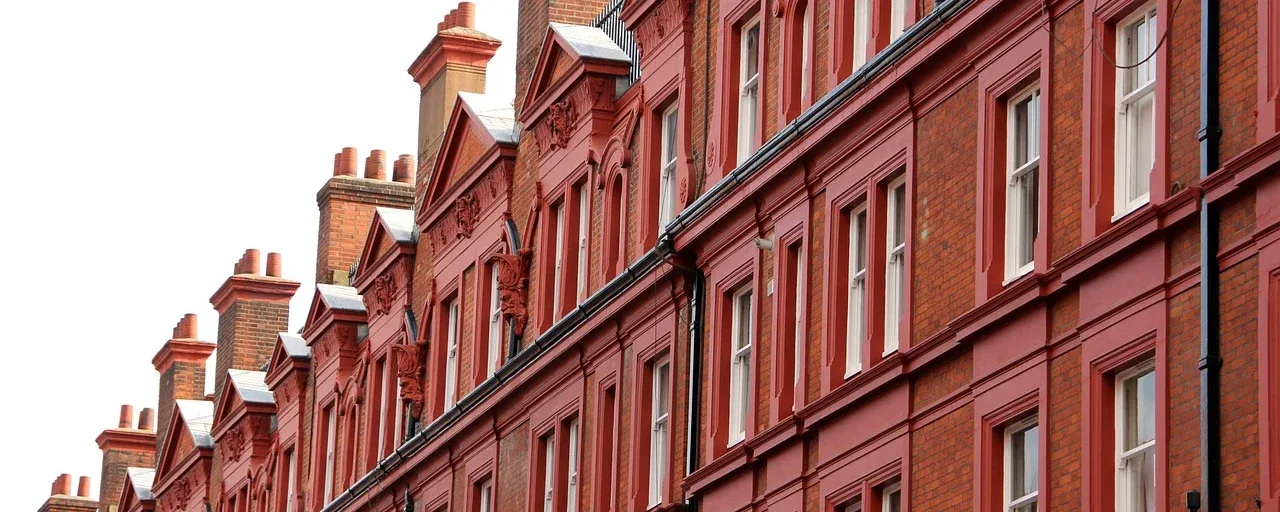 Ornate red-brick residential façades and chimneys in London