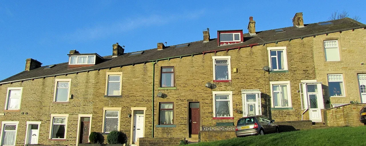 Stone terraced houses with front gardens in Colne