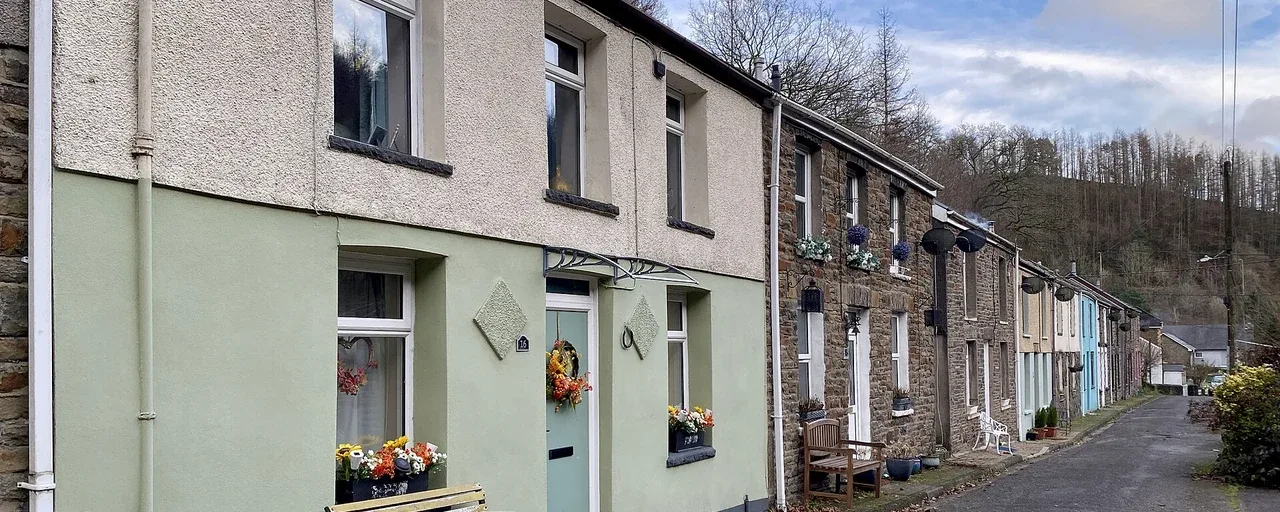 Terraced houses beside a quiet lane in Garw Fechan, with wooded hills behind Terraced houses beside a quiet lane in Garw Fechan, with wooded hills behind