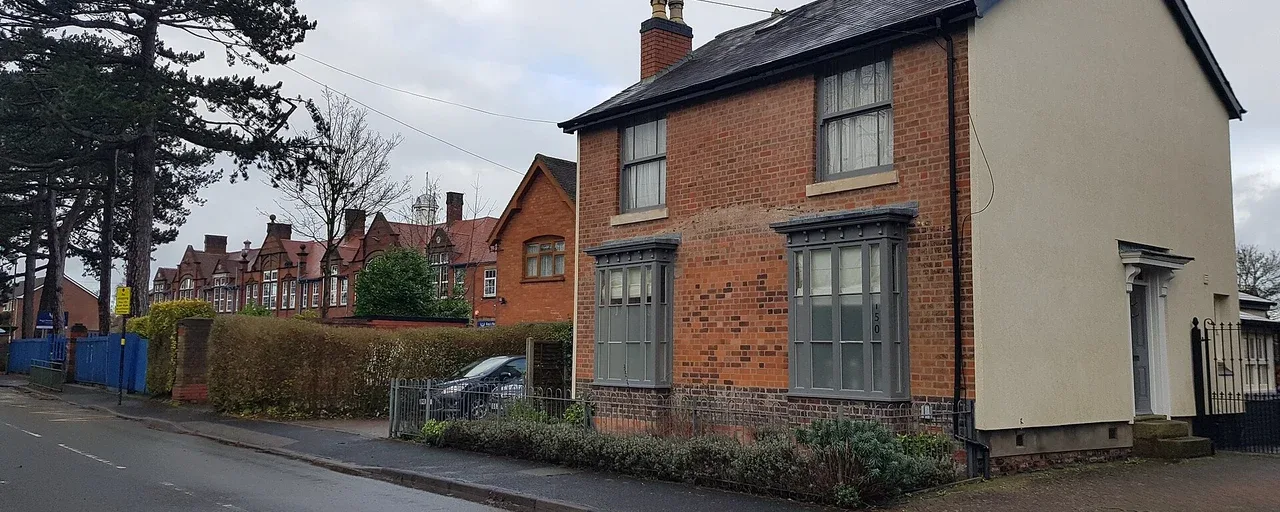 Brick semi-detached cottages beside Northfield Road in Birmingham